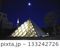 都会の風景ライトアップされたピラミッド型の建造物と月 133242726