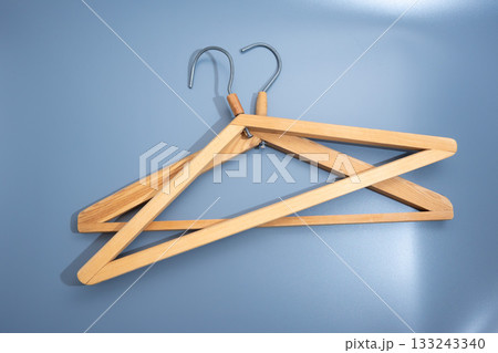 Empty wooden clothes hanger with metal hook 133243340