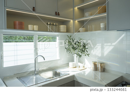 modern kitchen with white ceramic tiles and white worktop 133244081
