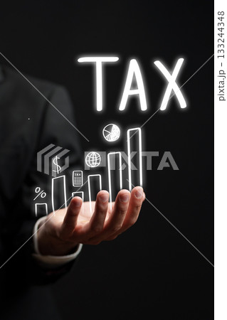 Businessman illustrating tax growth through a glowing graph in a dark setting Businessman illustrating tax growth through a glowing graph in a dark setting 133244348
