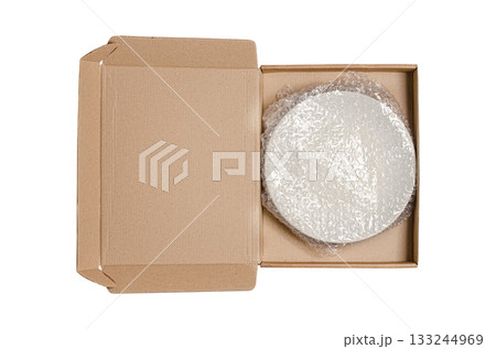 An open cardboard box with bubble wrap. The concept of packaging parcels with fragile cargo. Isolated on white An open cardboard box with bubble wrap. The concept of packaging parcels with fragile cargo. Isolated on white 133244969