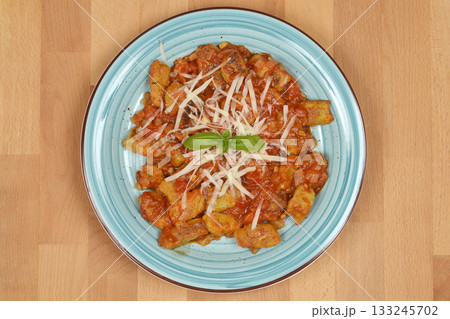 Zucchini gnocchi topped with tomato sauce, 133245702