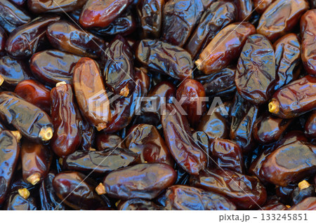 Delightful array of dates showcasing rich colors and textures in a bustling market Delightful array of dates showcasing rich colors and textures in a bustling market 133245851