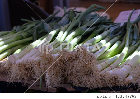 Fresh leeks displayed in a bustling farmers market during the vibrant morning hours of late spring Fresh leeks displayed in a bustling farmers market during the vibrant morning hours of late spring 133245865