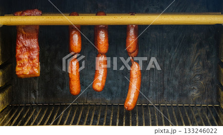 Smoked sausages meat hanging in smokehouse 133246022
