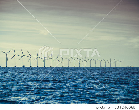 Wind turbines power generator farm along coast sea 133246069