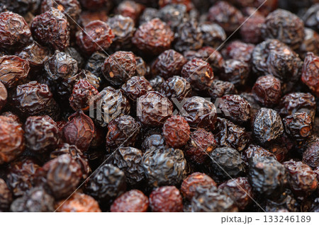 Rich hues of dried berries scattered across a rustic wooden surface in vibrant market display Rich hues of dried berries scattered across a rustic wooden surface in vibrant market display 133246189