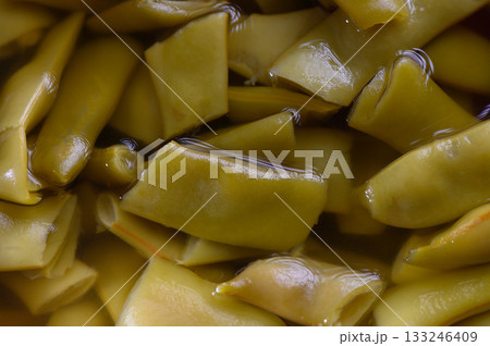 Vibrant green pickled vegetables soaking in brine for a flavorful culinary experience Vibrant green pickled vegetables soaking in brine for a flavorful culinary experience 133246409
