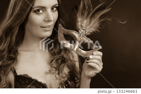 Closeup woman face with carnival mask on dark Closeup woman face with carnival mask on dark 133246661