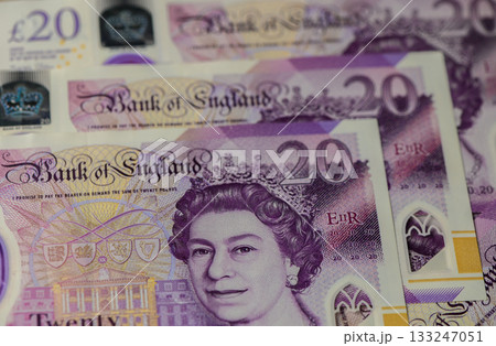 Colorful twenty-pound notes showcasing the intricate details of UK currency design and royal imagery 133247051