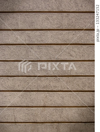 Textured wall reveals layers of simplicity and elegance under soft ambient light 133247152