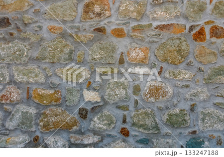 Exploring textures and colors of an ancient stone wall in a quaint village during golden hour Exploring textures and colors of an ancient stone wall in a quaint village during golden hour 133247188
