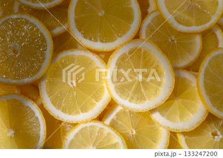 Freshly sliced lemons arranged beautifully for a vibrant kitchen display full of zest and flavor Freshly sliced lemons arranged beautifully for a vibrant kitchen display full of zest and flavor 133247200