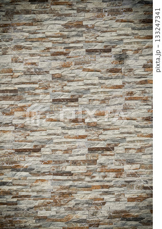 Elegant stone wall featuring textured layers in warm tones with a rustic charm for home decor 133247341
