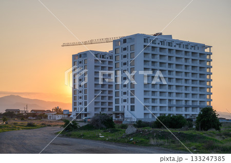 New urban development rises against a stunning sunset in a tranquil landscape 133247385