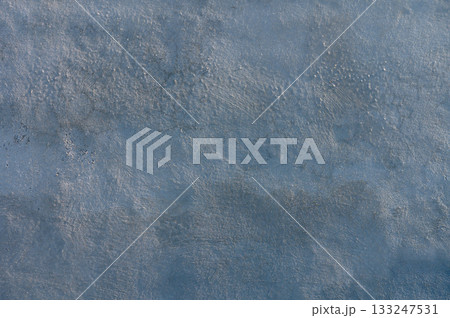 Swirling shades of blue grace the textured surface of a tranquil water body under soft sunlight Swirling shades of blue grace the textured surface of a tranquil water body under soft sunlight 133247531