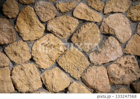 Discovering the beauty of rustic stone walls in a sunlit courtyard Discovering the beauty of rustic stone walls in a sunlit courtyard 133247568