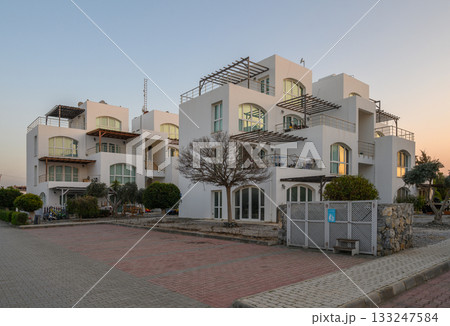 Modern architecture blends with nature at twilight in a serene residential area 133247584