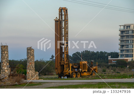 Heavy machinery at work on a construction site during a serene afternoon landscape Heavy machinery at work on a construction site during a serene afternoon landscape 133247916
