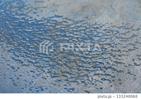 Cracked blue surface revealing intricate patterns in a serene outdoor setting at midday Cracked blue surface revealing intricate patterns in a serene outdoor setting at midday 133248068