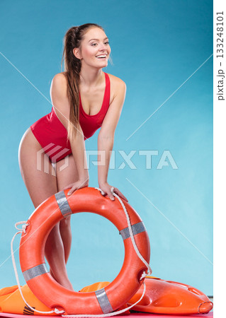 Lifeguard woman on duty with ring buoy lifebuoy. 133248101