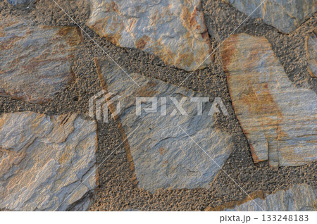 Intricate patterns of natural stone showcasing earthy tones and textures in a rustic setting Intricate patterns of natural stone showcasing earthy tones and textures in a rustic setting 133248183