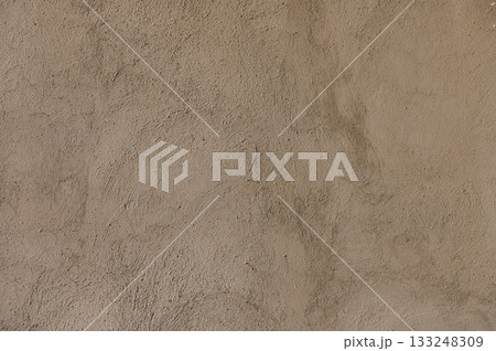 Rough textures of adobe walls reveal the beauty of traditional craftsmanship in a sunlit desert landscape 133248309