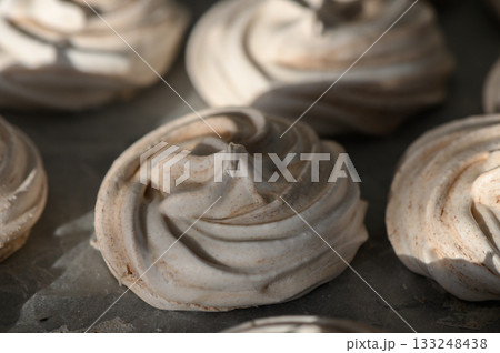 Swirls of meringue drying in warm sunlight at a cozy kitchen setting 133248438