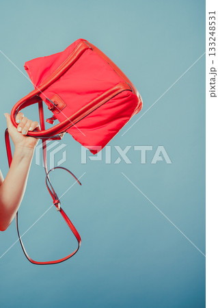 Closeup of fashion woman hand with red handbag. Closeup of fashion woman hand with red handbag. 133248531