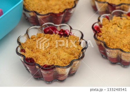 Delightful cherry crumble cups baked to perfection with a golden topping and rich berry flavor Delightful cherry crumble cups baked to perfection with a golden topping and rich berry flavor 133248541