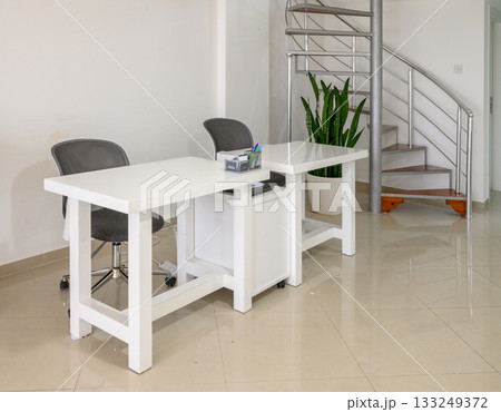 Modern workspace with minimalist design and green plants in bright, inviting environment 133249372