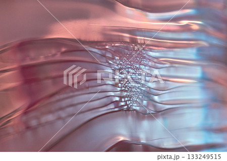Abstract pink and blue wavy glass texture with light reflections and ripples 133249515
