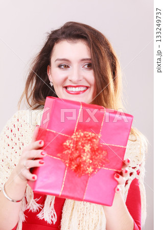 Happy girl holding present. 133249737