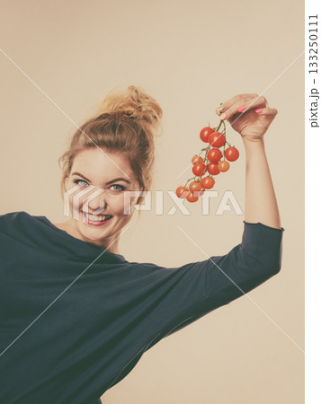 Woman holding fresh cherry tomatoes 133250111