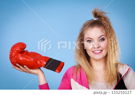 Funny girl in red gloves playing sports boxing Funny girl in red gloves playing sports boxing 133250127