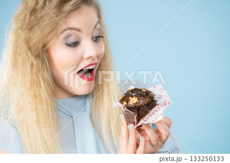 Attractive woman holds cake in hand 133250133