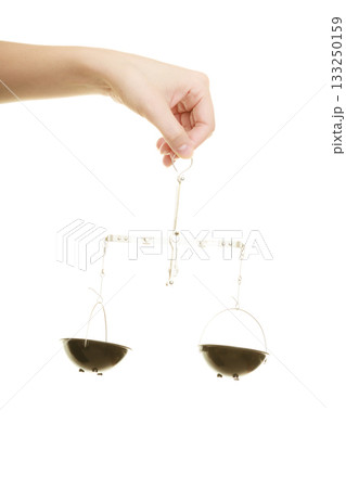 Law court. Female hand holds scales symbol of justice. 133250159