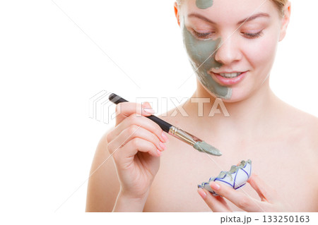 Woman applying face mask with brush 133250163