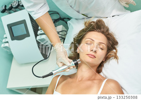 Young caucasian female receiving non-invasive facial treatment at a spa clinic Young caucasian female receiving non-invasive facial treatment at a spa clinic 133250308