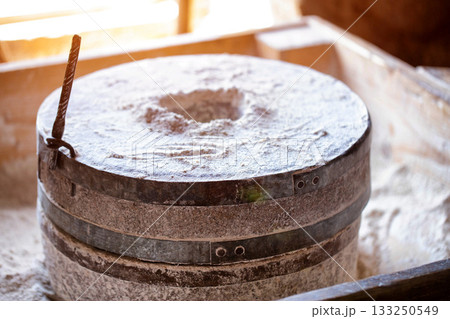 millstones for breaking grain into flour, antique, close-up 133250549
