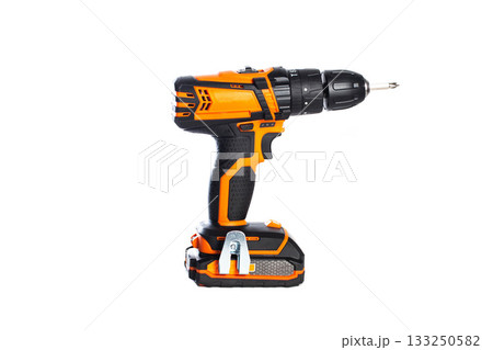 Cordless power drill in bright orange color with a black drill bit for home improvement projects 133250582