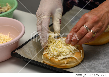 Delicious preparation of a savory sandwich with fresh toppings in a cozy kitchen setting Delicious preparation of a savory sandwich with fresh toppings in a cozy kitchen setting 133251277