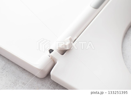 Broken hinge on white toilet seat and lid, close-up, industry, low quality plastic Broken hinge on white toilet seat and lid, close-up, industry, low quality plastic 133251395