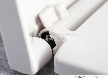 Broken hinge on white toilet seat and lid, close-up, industry, low quality plastic Broken hinge on white toilet seat and lid, close-up, industry, low quality plastic 133251396