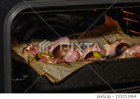 Savory marinated meat skewers with lime roasting in an oven at a cozy home kitchen Savory marinated meat skewers with lime roasting in an oven at a cozy home kitchen 133251464