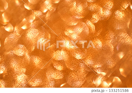 Abstract pattern of orange and gold light reflections creating a warm Abstract pattern of orange and gold light reflections creating a warm 133251586