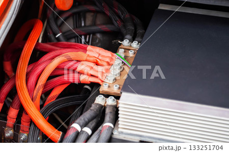 Closeup Of High-Current Power Cables For Automotive Sound System. Thick Red And Black Wires Connect To Distribution Block. 133251704