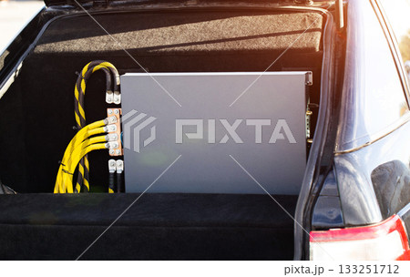 Powerful Car Audio Amplifier In Vehicle Trunk. Thick Wires Connect Professional Sound Equipment. 133251712