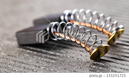 Electric motor brushes on gray background, macro, industry 133251725