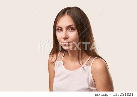 Young caucasian female in white tank top with straight hair and neutral 133251821